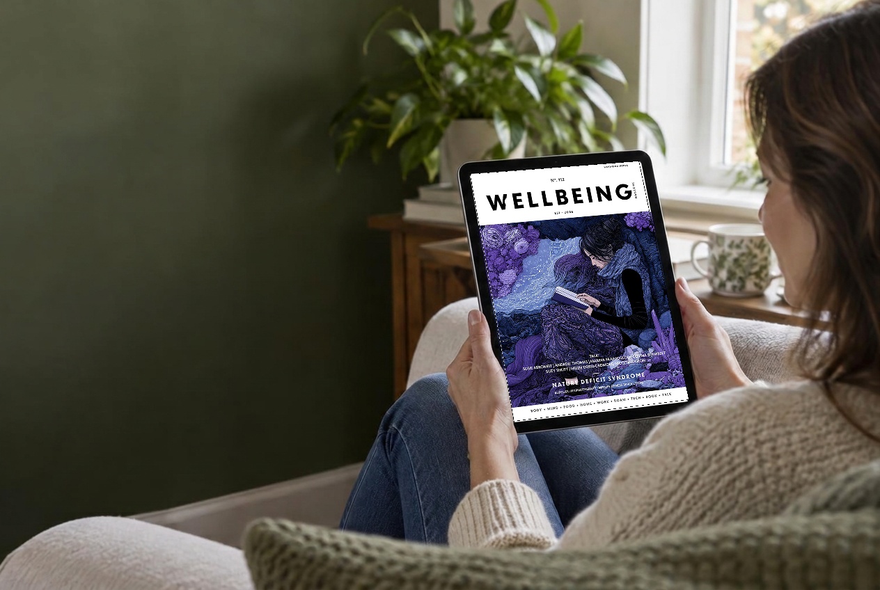 A reader enjoying Wellbeing magazine on her iPad at home